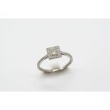 AN EARLY 20TH CENTURY DIAMOND CLUSTER RING the central circular-cut diamond is millegrain set within