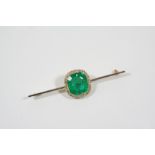 AN EARLY 20TH CENTURY EMERALD AND DIAMOND CLUSTER BROOCH the octagonal-cut emerald is set within a