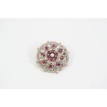 A RUBY AND DIAMOND BROOCH the flowerhead design is set overall with circular-cut rubies and