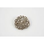 A VICTORIAN DIAMOND BROOCH of openwork foliate form, the centre flowerhead mounted with a cushion-