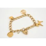 A GOLD CHARM BRACELET with padlock clasp and suspending four 9ct. gold charms, total weight 18.4