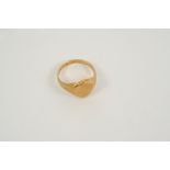 AN 18CT. GOLD SIGNET RING of shield shape, engraved with initials, 9.6 grams, size S.