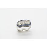 A SAPPHIRE AND DIAMOND RING centred with three brilliant-cut diamonds weighing 2.10 carats in