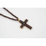 A VICTORIAN GARNET CRUCIFORM PENDANT AND NECKLACE the garnet cross set with a rose-cut diamond, in