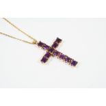 AN AMETHYST CRUCIFORM PENDANT formed with square-shaped amethysts, in 9ct. gold, on a 9ct. gold