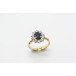 A SAPPHIRE AND DIAMOND CLUSTER RING the oval-shaped sapphire is set within a surround of ten