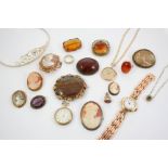 A QUANTITY OF JEWELLERY including various carved shell cameo brooches, a gold wristwatch etc.