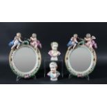 PAIR OF MEISSEN STYLE OVAL, PORCELAIN MIRRORS, with easel backs, surmounted by cherubs and flower