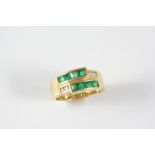 AN EMERALD AND DIAMOND RING the gold band is mounted with eight calibre-cut emeralds and four