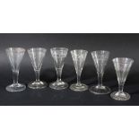 GROUP OF SIX GLASSES, late 18th and early 19th century, each with engraved, drawn trumpet bowls