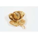 A GOLD PLATED ROSE BROOCH BY CHRISTIAN DIOR realistically formed, signed to the reverse Chr. Dior,