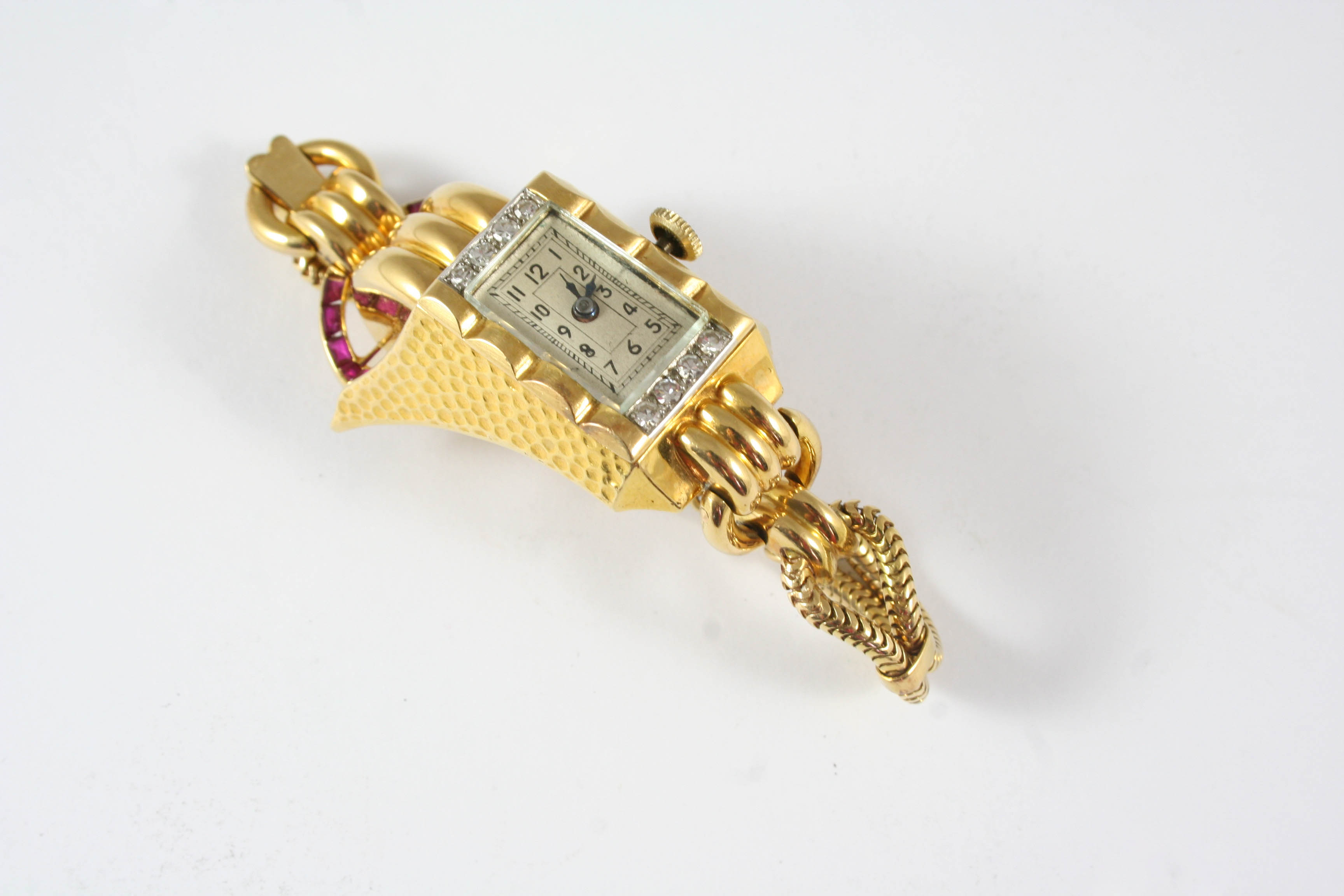 A LADY'S 14CT. GOLD, DIAMOND AND RUBY WRISTWATCH the rectangular-shaped dial with Arabic numerals