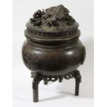 JAPANESE BRONZE CENSER AND COVER, Meiji, of tripod, ovoid form applied with foliate roundels on