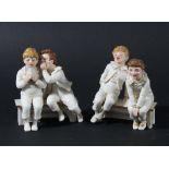 PAIR OF ROYAL WORCESTER GROUPS BY JAMES HADLEY, each modelled as two boys sat on a bench with a