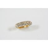 A DIAMOND HALF HOOP RING set with seven circular-cut diamonds, in 18ct. yellow gold. Size N.