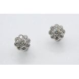 A PAIR OF DIAMOND CLUSTER STUD EARRINGS of flowerhead form, the circular-cut diamond is set within a