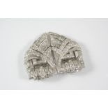 AN ART DECO DIAMOND DOUBLE CLIP BROOCH the arched openwork scrolling design is mounted with