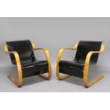 PAIR OF ALVAR AALTO ARMCHAIRS a pair of Model 31 laminated cantilever wooden armchairs, with