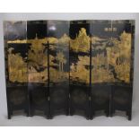 CHINESE BLACK LACQUERED AND GILT SIX FOLD SCREEN, 19th century, gilded with a continuous scene of