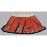 CHINESE SILK SKIRT, late 19th or early 20th century, embroidered with flowers on a red ground, waist