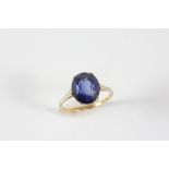 A SYNTHETIC SAPPHIRE SINGLE STONE RING the oval-shaped synthetic sapphire is set in gold. Size K 1/