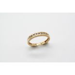 A DIAMOND HALF HOOP RING set with ten circular-cut diamonds, in 18ct. gold. Size N.