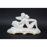 HUTSCHENREUTHER ART DECO FIGURE GROUP a white glazed figure of Pan playing a flute, seated next to