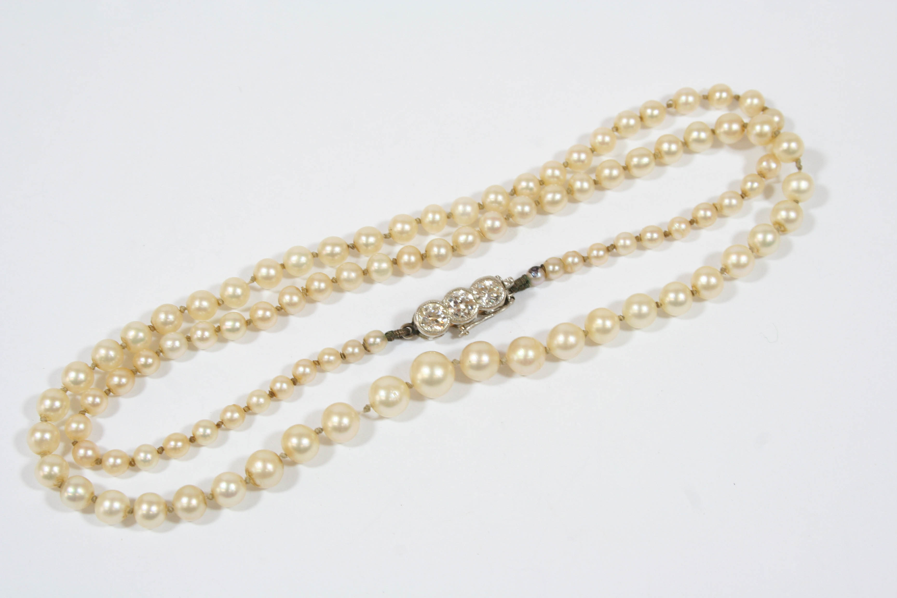 A SINGLE ROW GRADUATED NATURAL PEARL NECKLACE the pearls graduate from 2.5mm. to 6.0mm. to a gold