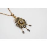 A VICTORIAN DIAMOND PENDANT the flowerhead design is centred with an oval rose-cut diamond and