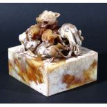 LARGE CHINESE SOAPSTONE SEAL, carved with a chilong and two young, 10cm square and high
