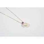 A SOUTH SEA PEARL AND RUBY PENDANT the pearl measures approximately 11.0mm., and is suspended from a