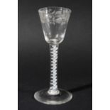 WINE GLASS, circa 1760, the rounded bowl with a band of floral engraving on a single series opaque