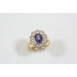 A SAPPHIRE AND DIAMOND CLUSTER RING the oval-shaped sapphire is set within a surround of ten