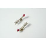 A PAIR OF ART DECO RUBY AND DIAMOND ARROW EARRINGS each mounted with baguette-cut and circular-cut