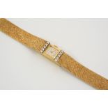 A LADY'S 18CT. GOLD AND DIAMOND WRISTWATCH BY BAUME & MERCIER the signed square-shaped dial with dot