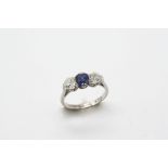 A SAPPHIRE AND DIAMOND THREE STONE RING the oval-shaped sapphire is set with two cushion-shaped