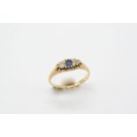 A SAPPHIRE AND DIAMOND THREE STONE RING the circular-cut sapphire is set with two circular-cut