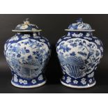 PAIR OF CHINESE BLUE AND WHITE JARS AND COVERS, Kangxi style, of swollen baluster form painted