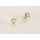 A PAIR OF DIAMOND STUD EARRINGS each set with a circular-cut diamond, in gold.