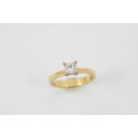 A DIAMOND SOLITAIRE RING set with a princess-cut diamond, in 18ct. gold. Size N.