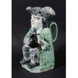 PEARLWARE TOBY JUG, circa 1800, the seated toby holding a jug, blue sponged tricorn hat and trousers