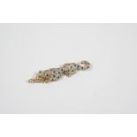 A DIAMOND AND SAPPHIRE LEOPARD BROOCH formed as a leopard lying down, set overall with circular-