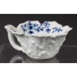 WORCESTER MOULDED BUTTER BOAT, mid 18th century, blue painted in the Pickle Leaf Daisy pattern on