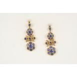 A PAIR OF SAPPHIRE AND DIAMOND DROP EARRINGS of foliate form, each set with graduated circular-cut