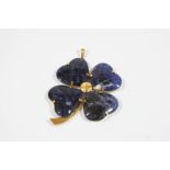 A SODALITE SHAMROCK PENDANT formed with four sections of sodalite, in gold, 6cm. wide.