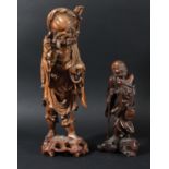 CHINESE ROOTWOOD CARVING, of a traveller holding his hat hooked on his staff over his shoulder,