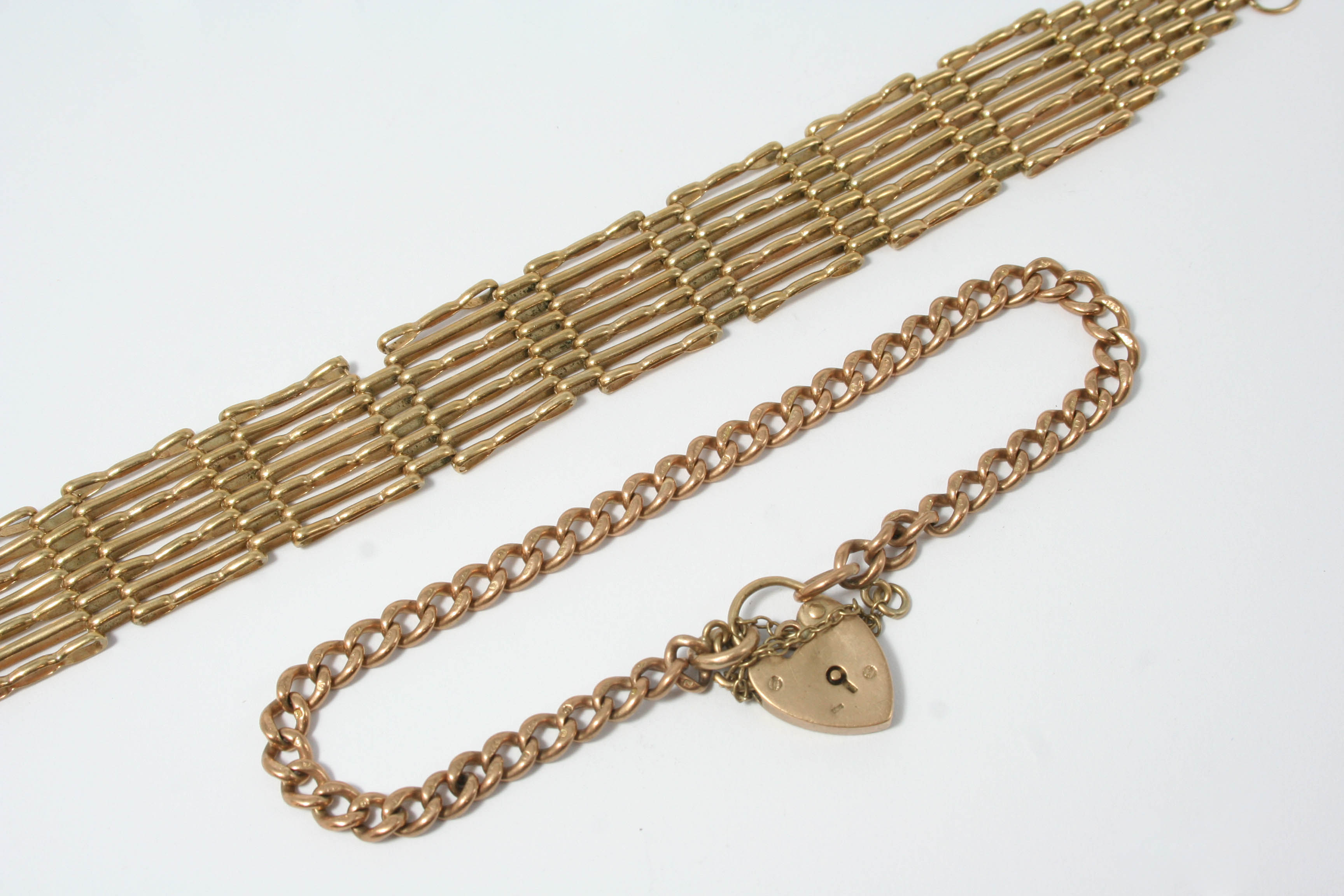 A GOLD GATE LINK BRACELET clasp missing, 14 grams, together with a 9ct. gold curb link bracelet,