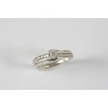 A DIAMOND SOLITAIRE RING the circular-cut diamond weighs 0.33 carats and is set with nine