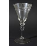 18TH CENTURY LIGHT BALUSTER WINE GLASS, the rounded funnel shaped bowl engraved with slylised floral