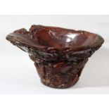 CHINESE BUFFALO HORN LIBATION CUP, carved with figures on a punt amongst pine trees and rocks,